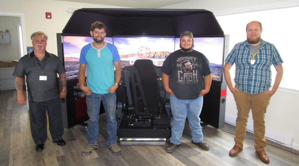 Group of students and instructors with the driving simulator